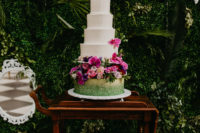 12 The wedding cake was white decorated with pink blooms and on a pillow of lush bright flowers