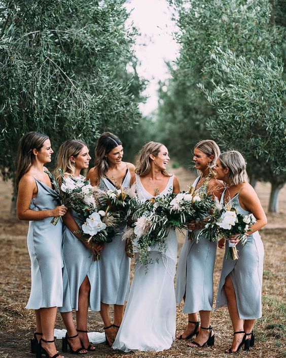 light blue slip midi dresses paired with black shoes for a romantic spring or summer bridesmaid look