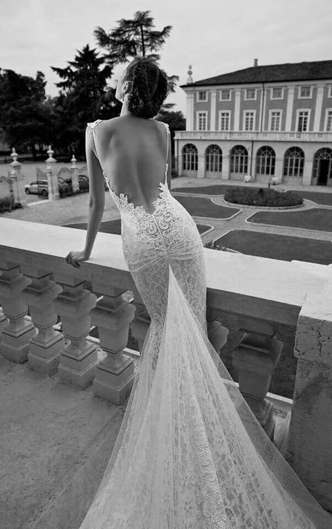 a lace mermaid wedding dress with no back and a long train is gorgeous and luxurious