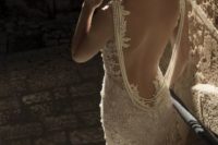 15 a lace sheath wedding dress with a pearl back necklace that makes a fashion statement