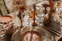 16 a chic tablescape with terracotta chargers, matching candles and rust-colored blooms