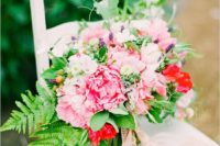 17 a chic summer wedding bouquet with red and pink blooms, greenery and lavender for much texture