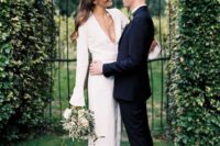 20 a modern plain wedding dress with bell sleeves and a plunging neckline