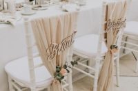 20 a super chic neutral wedding reception space done with blush blooms and greenery and some photos