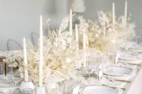 21 a refined white reception tablescape done with lunaria and dried branches, candles, plates and some gold cutlery