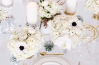 24 a chic white wedding tablescape with lush blooms, candles and gold touches – cutlery and gold rims