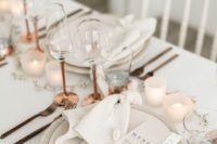 27 an all-neutral and chic wedding tablescape with candles, brass and copper touches and textural matte plates