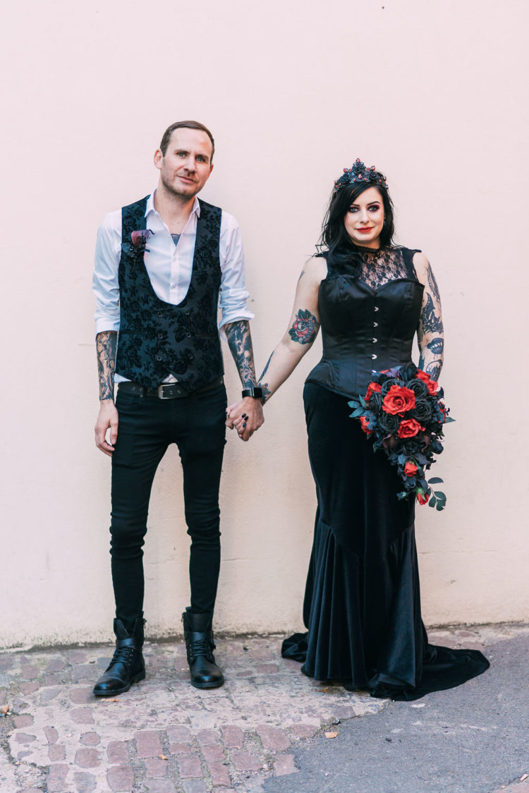 a boldd Victorian inspired black wedding dress with a corset and a velvet skirt plus a lace top