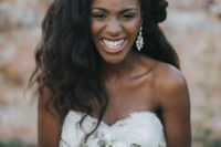 a stylish wedding hairstyle of elegant waves and with one side tucked is very romantic