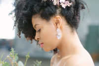 natural curls swiped up and accented with a gold botanical hairpiece to make it look more chic