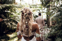 04 She was rocking a braided half updo with dried blooms and greenery tucked into it