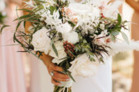 04 The wedding bouquets were super lush, white and veyr textural, with berries and greenery