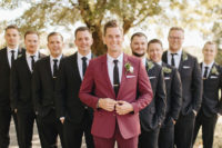 05 The groom was wearing a maroon suit with a black tie, the groosmen were rocking black suits with black ties