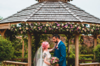 05 The wedding ceremony took place in a wooden pergola decorated with blush bright blooms