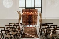 06 The wedding ceremony space was done with a carved wooden screen as a backdrop, rugs and some pampas grass