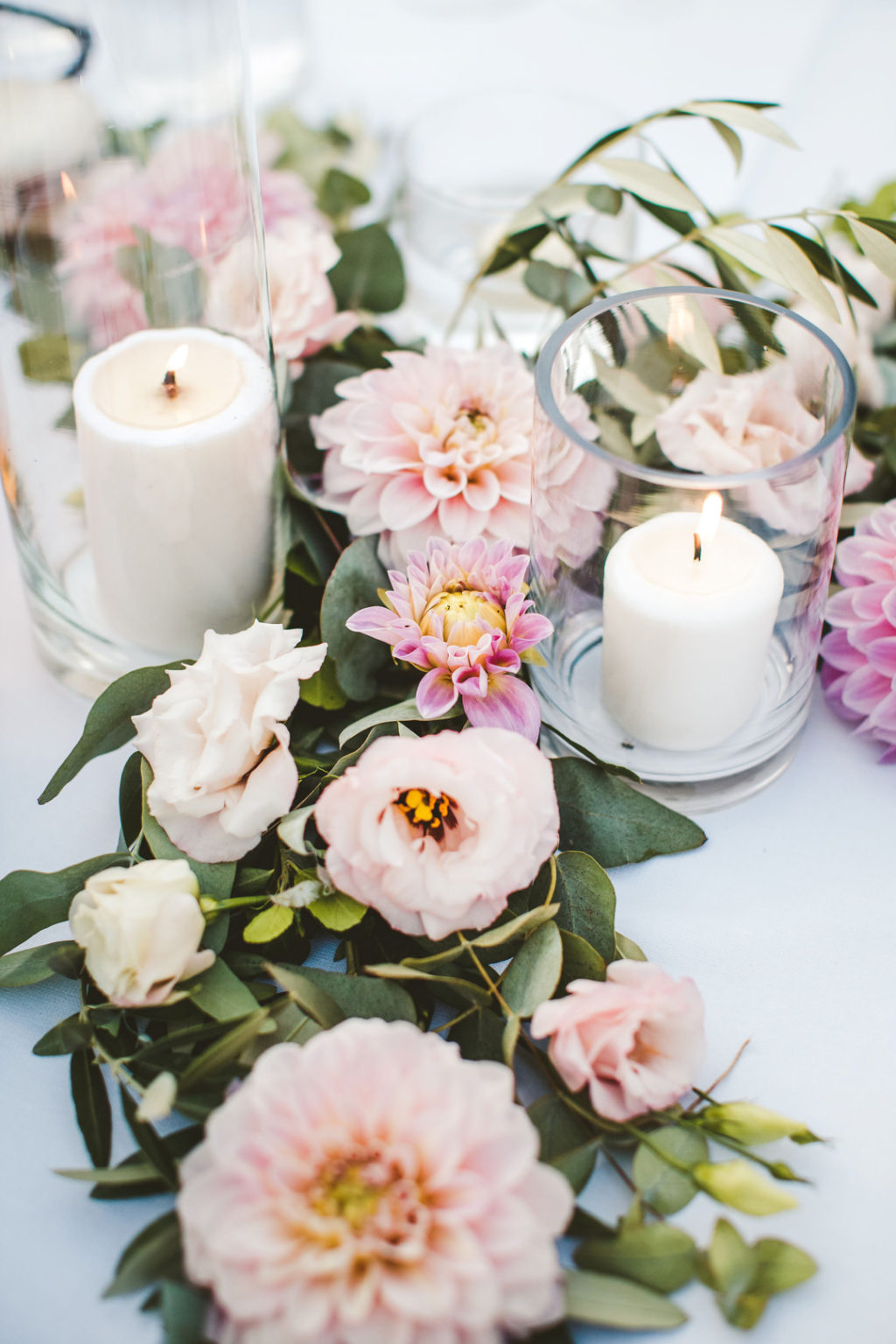 The weddin decor was lush, tender and romantic, with candles and pink blooms