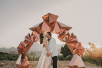 07 There was a bold copper geometric 3D wedding arch as a backdrop for the portraits