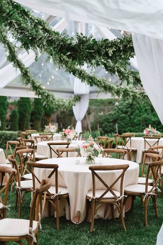 lush greenery garlands over the reception make the space stunning and you won't need much money