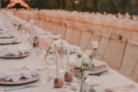 09 The tables were decorated with pink chargers, copper candle holders, white and pink flowers and white napkins