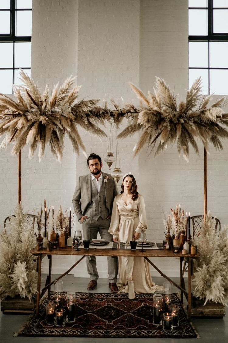 The wedding reception was done with pampas grass, black candles, terracotta vases