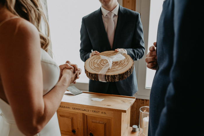 The wedding rings were presented on a wood slice