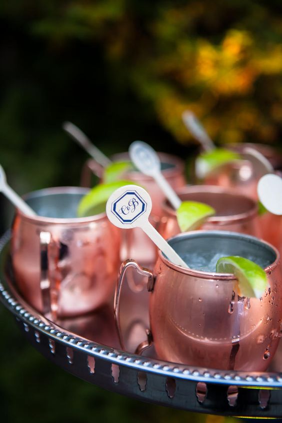 signature wedding drinks in copper mugs and with wooden drink stirrers with monograms