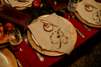12 The wedding tablescape was done with apples, acorns, wood slicesm embroidered napkins and glasses