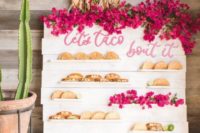 14 a bright and fun taco wall decorated with bougainvillea is a very creative and cheerful idea for a Mexican food loving couple