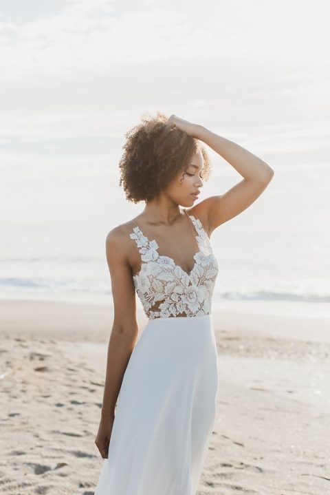 a floral applique sleeveless top with illusion detailing and a sleek white high waisted A line skirt