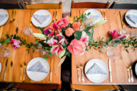 16 bright reception tables done with colorful florals and leopard print napkins plus ggold cutlery for more elegance