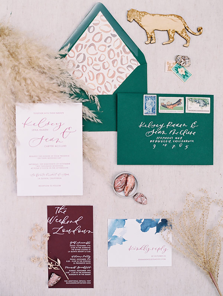 colorful wedding stationary in burgundy, blue and emerald, with a leopard print and bold calligraphy