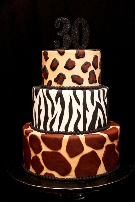 a refined wedding cake with a number of animal prints and a black glitter tier on top is wow