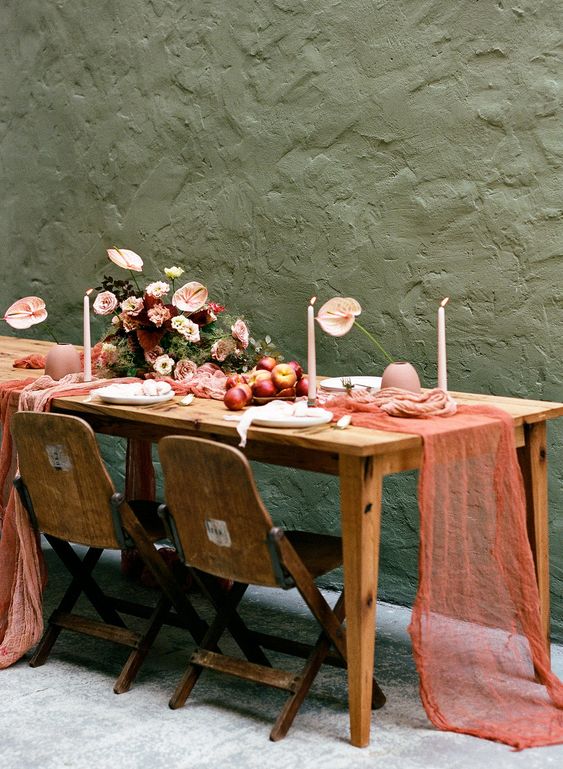 a fall wedding table with a colorufl table runner