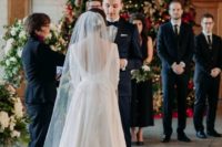 a cool micro holiday wedding indoors, with a large Christmas tree as a backdrop is a gorgeous idea