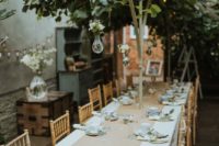 a cozy micro wedding reception with lush greenery, white blooms and elegant tableware is veyr intimate