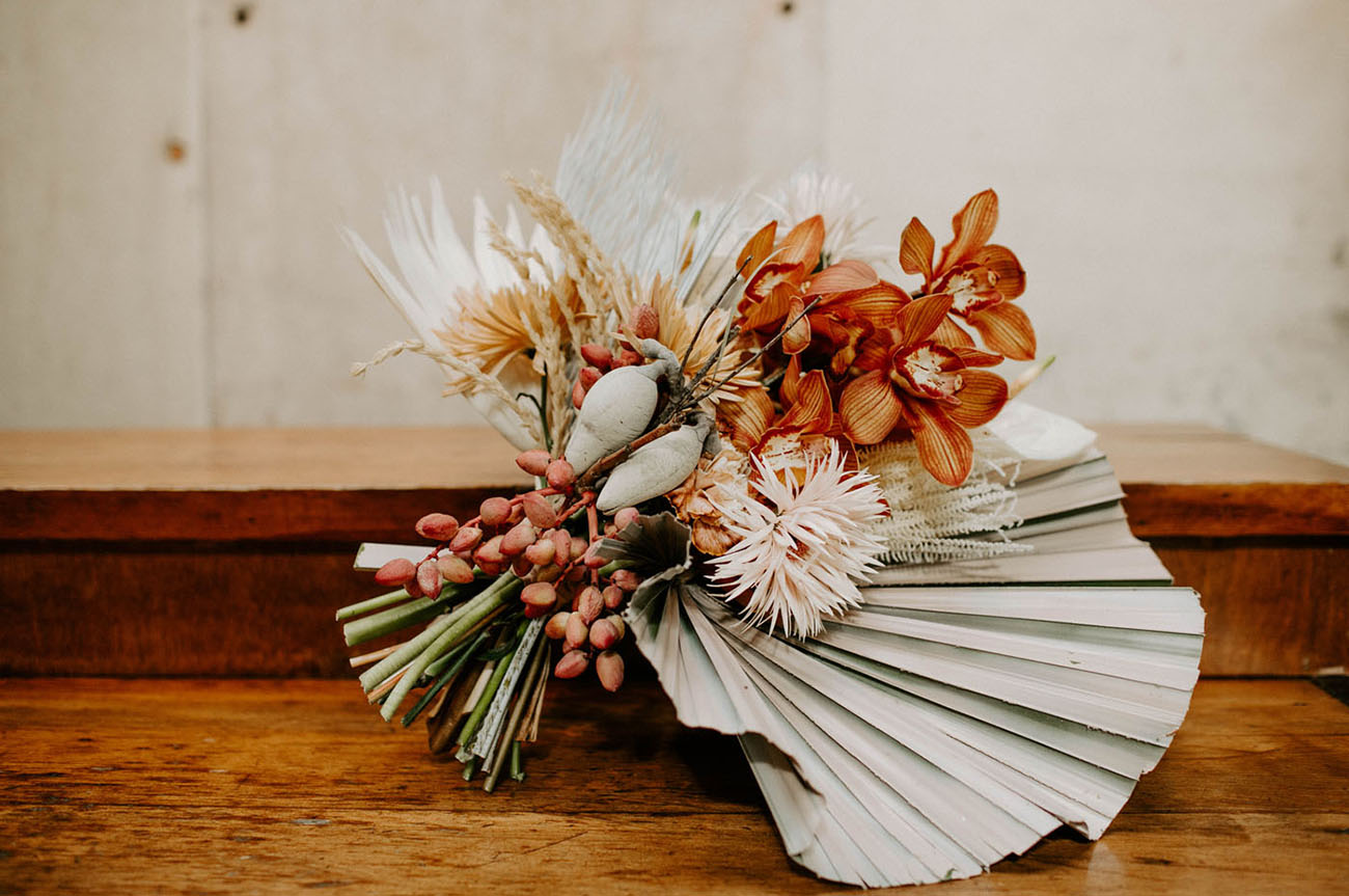 The wedding bouquet was done with bright blooms and lot sof dried elements and leaves