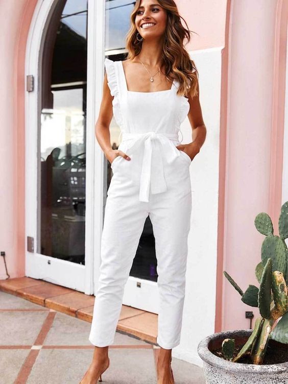 a chic and simple white jumpsuit with ruffle straps, a square cut and pockets for a modern and casual bride
