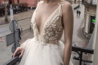 02 a delicate and refined wedding dress with an applique and embellished bodice with a plunging neckline and a full tulle skirt