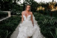 02 a gorgeous wedding ballgown with a plunging strapless neckline, a full feather skirt and white booties