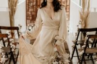 03 a neutral silk wrap wedding dress paired with tan suede booties and statement earrings are a trendy combo