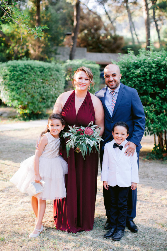 The bridesmaid was wearing a burgundy A-line dress
