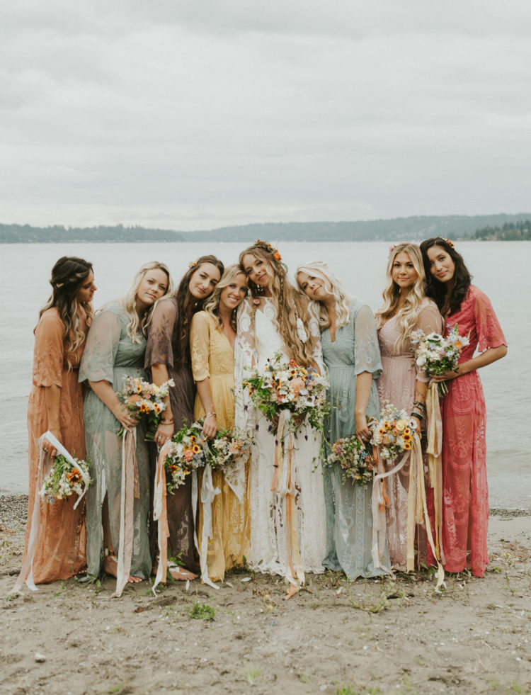 The bridesmaids were wearing pastel and muted color lace dresses and carrying similar bouquets