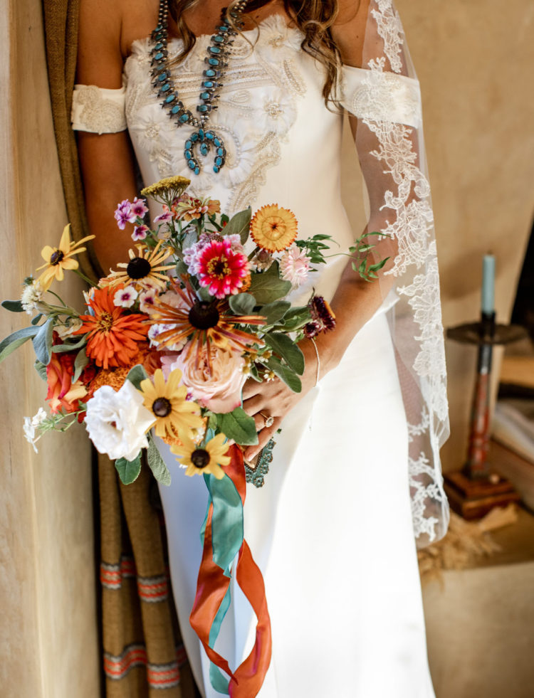 A turquoise necklace and a bright bouquet finished off the bridal look