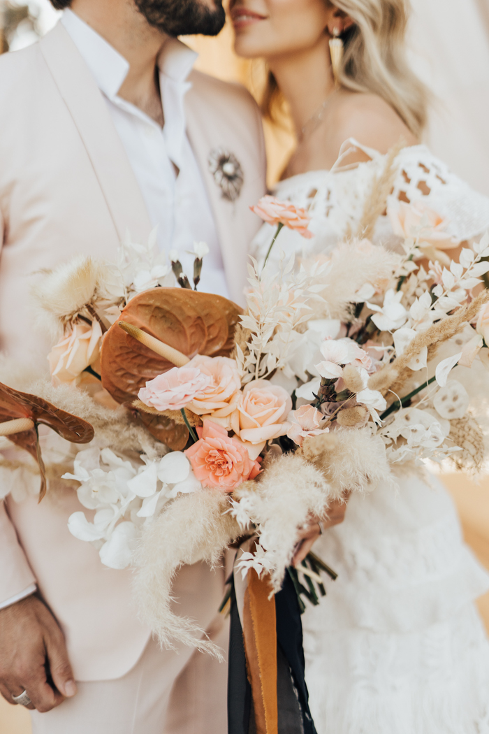 The wedding bouquet was done with blush and white blooms, pampas grass and other dried stuff