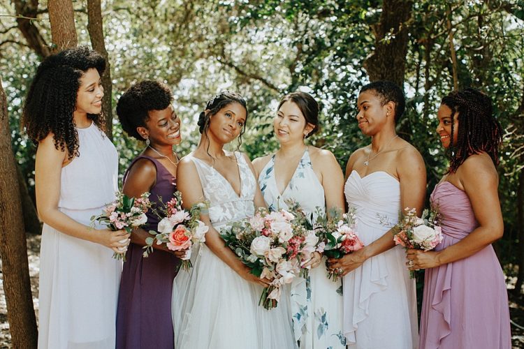The bridesmaids were rocking mismatching white, mauve, purple and floral maxi dresses