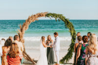 06 The wedding arch was a round one, of greenert and pampas grass plus boho rugs