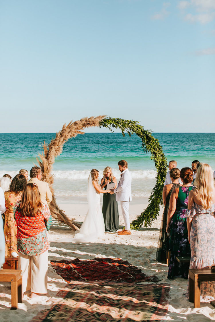 The wedding arch was a round one, of greenert and pampas grass plus boho rugs