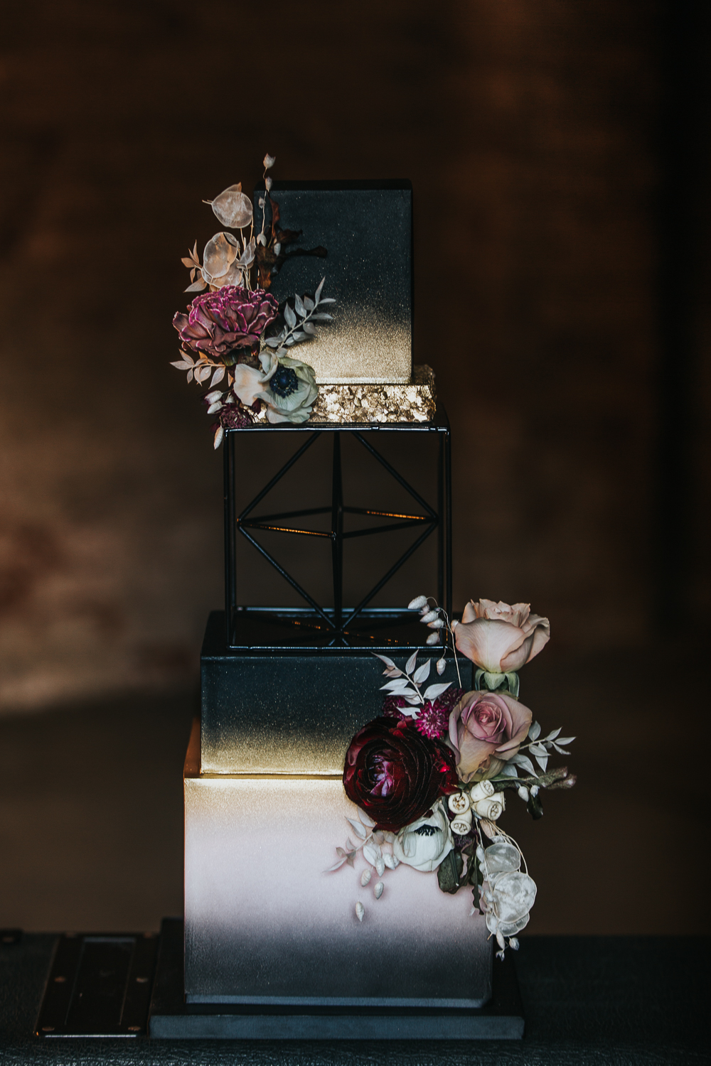 The wedding cake was a white, black and gold glitter one, with bright blooms and greenery