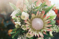 08 The wedding bouquet was done with lots of greenery, white blooms and a large king protea