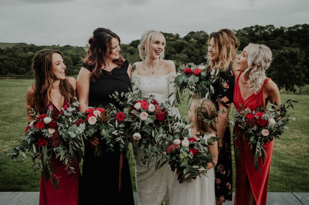The bridesmaids were wearing mismatching red and black dresses